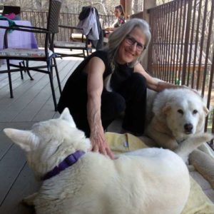 Zohara with two of her dogs, camera-shy Bella in front, and Omaha